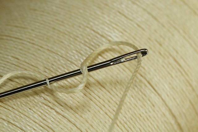 hands sewing heavy technical fabric